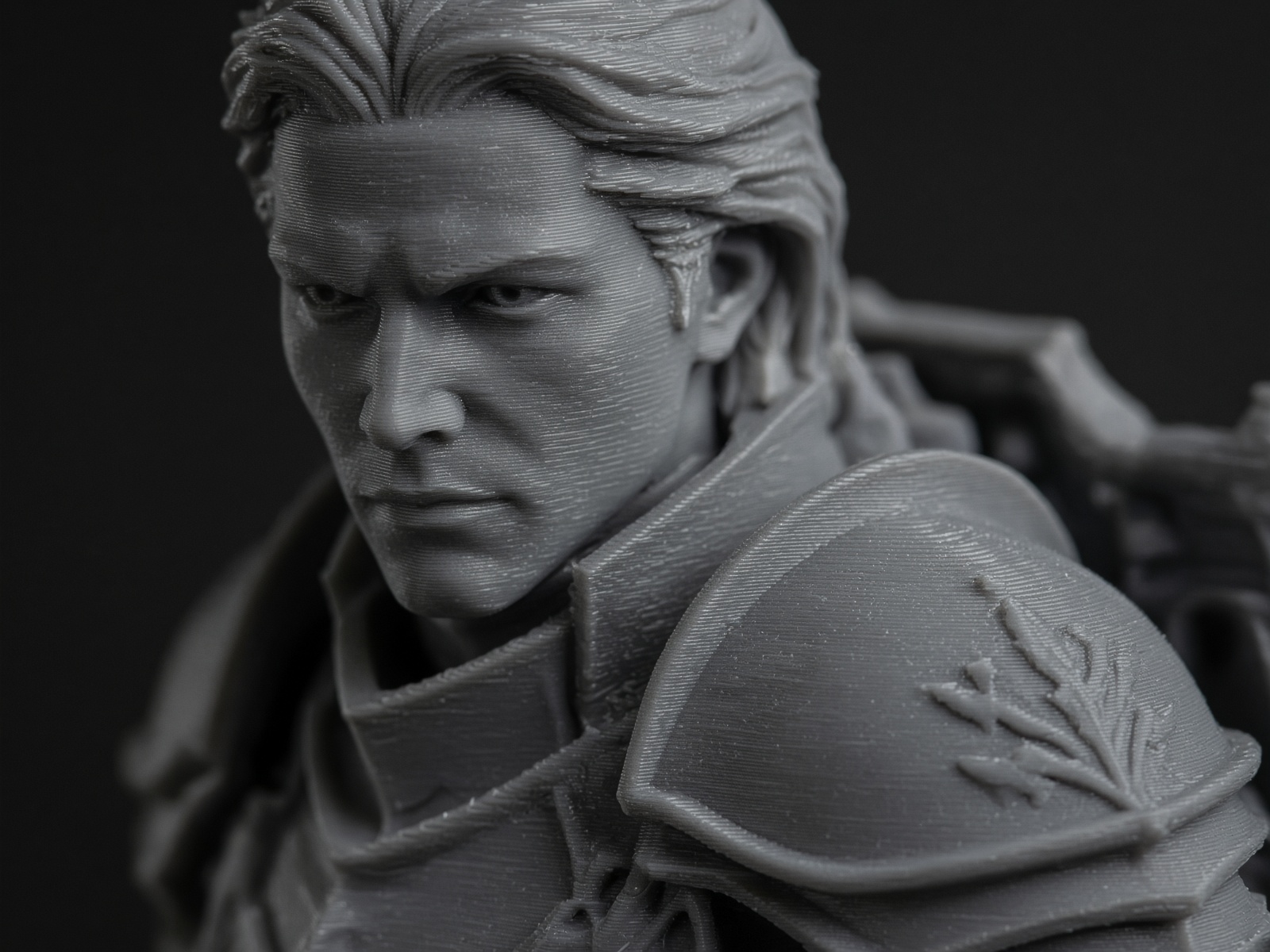 Macro of an unpainted grey PLA miniature face, showing fine horizontal layer lines under raking light.